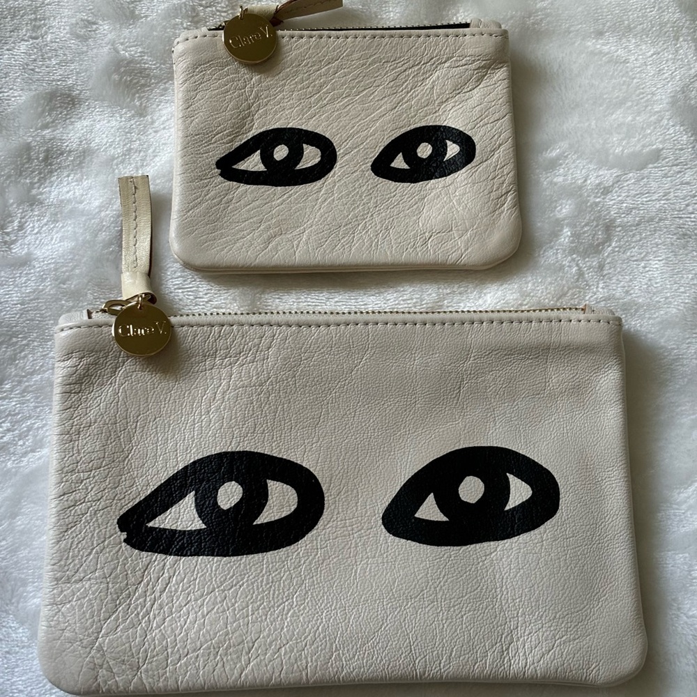 Clare V. Cream and Black Eye Clutches